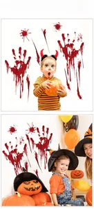 Close-up of Halloween bloody handprint wall decals with red blood splatters on a white wall