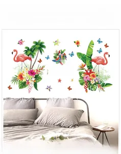 Close-up of tropical flamingo wall stickers with palm leaves and butterflies in a bedroom