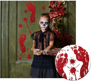 Detail view of bloody footprint stickers and red splatters on a wooden door background