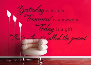Inspirational English quote wall decal on a red wall with modern armchair and lamp