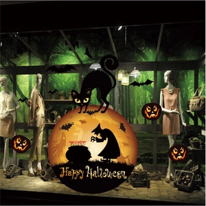 Detail of Halloween window stickers featuring witch silhouette, black cat and pumpkins