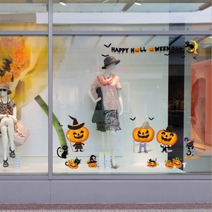 Halloween window stickers with pumpkins and bats on a glass store display