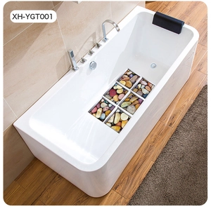 Detail of modern bathtub with transparent pebble display and silver metal faucet