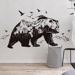 Artistic forest bear silhouette wall decal with mountains and birds in a modern interior
