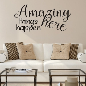 Detail view of Amazing Things Happen Here wall decal in a modern living room setup