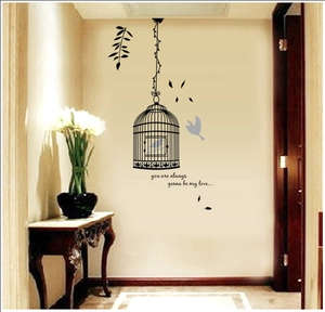 Decorative wall decal featuring black birdcages, birds and floral branches for room decor