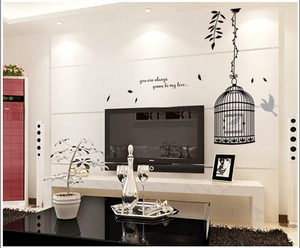 Birdcage wall stickers with birds and quotes on a living room wall