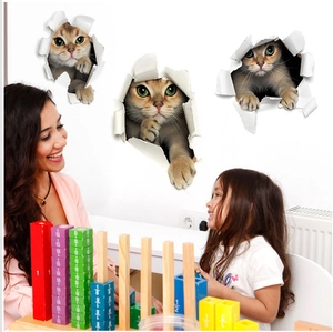 3D cat wall stickers showing three kittens emerging from a wall in a cozy living room decor