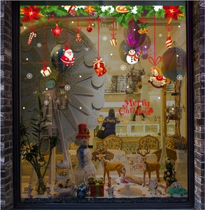 Christmas window stickers with Santa and snowman motifs on a store glass background