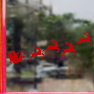 Red Christmas window sticker featuring Santa Claus in a sleigh with reindeer motifs