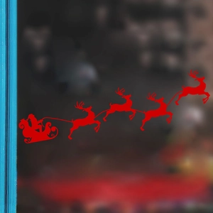Red Christmas window sticker featuring Santa Claus flying a reindeer sleigh over glass