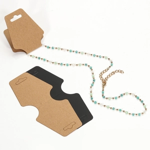 Colorful beaded necklace with gold metal clasp displayed on cardboard packaging cards