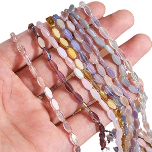 Faceted crystal glass beads for DIY necklaces shown on hand with rainbow reflections