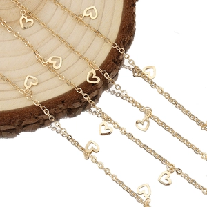 Golden heart-shaped chain necklace in pure copper with multiple layered link charms