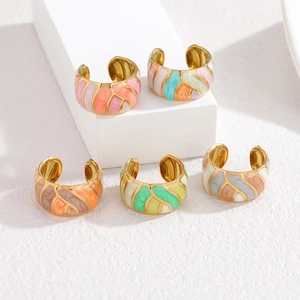 Detail of five-piece colorful enamel gold ear cuffs set on white tiered display