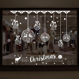White Christmas window stickers with reindeer, bells, and snowflakes on glass display