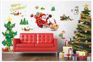 Detail view of festive Christmas tree and Santa wall stickers on a white wall decor