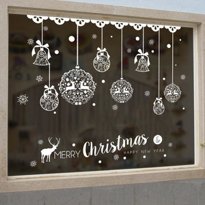 White Christmas window sticker with reindeer and snowflakes on a glass window