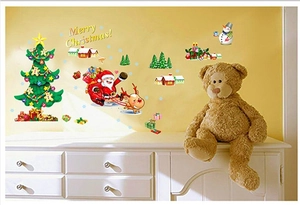 Detail of Christmas wall stickers featuring Santa, snowman and tree on a cozy home background