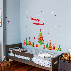 Merry Christmas wall stickers with red lettering and festive trees on a blue wall