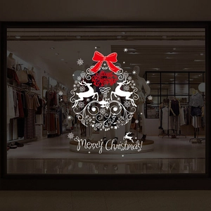 Festive window decal featuring white reindeer designs and a red Merry Christmas bow