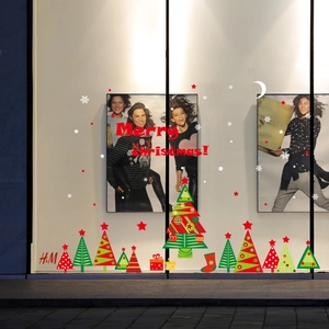 Festive Merry Christmas window decals featuring red lettering and colorful Xmas trees