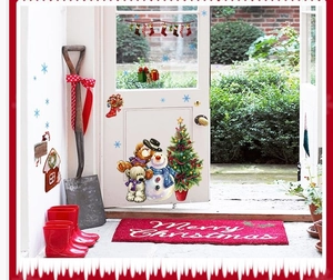Detail of Christmas wall decals with snowman, teddy bears, and decorated tree on a white door