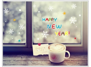 Winter window sticker detail featuring snowflakes and Happy New Year text with coffee
