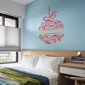 Detail of red spiral Christmas ball wall sticker with Merry Christmas text on blue wall