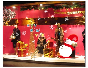 Detail of Christmas snowman window stickers with Happy New Year text and snowflakes