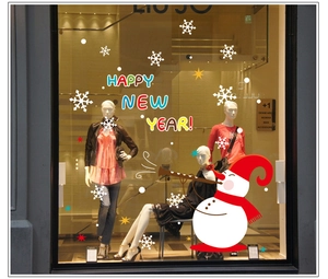 Detail of Christmas snowman window stickers with Happy New Year text and snowflakes