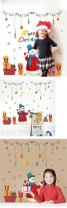 Detail of Merry Christmas wall stickers featuring snowmen and gift boxes on the wall