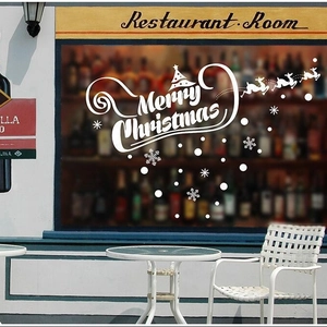 White Merry Christmas window decal with snowflakes and reindeer on restaurant glass