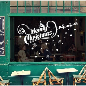 White Merry Christmas window stickers with reindeer and tree silhouettes for shop decor