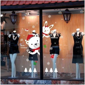 Christmas window stickers featuring white bears, rabbits, and snowflakes on glass