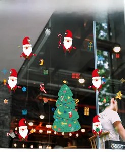 Detailed Christmas stickers display featuring Santa and tree on glass window decoration