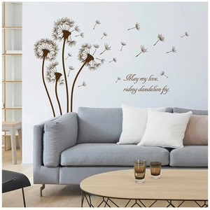 Detailed view of dark brown dandelion wall stickers with quote above a modern gray sofa