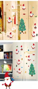 Close-up of Santa and Christmas tree stickers on glass door and white closet