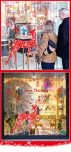 Detail of red Christmas reindeer window decals and hanging ornaments on a glass storefront