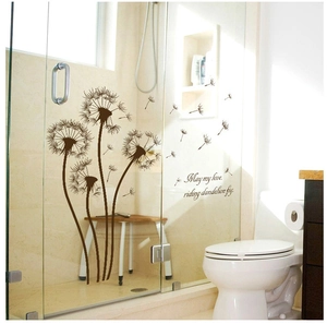 Detail of dandelion wall decal with English quote applied on a glass shower door
