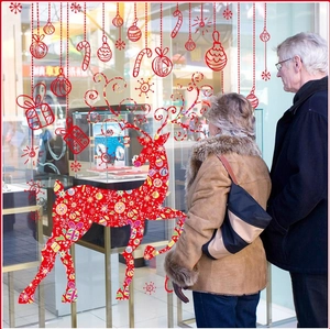 Red Christmas reindeer window stickers with festive hanging ornaments on glass