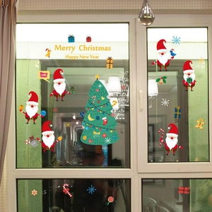 Christmas window stickers featuring Santa Claus and tree on a glass surface