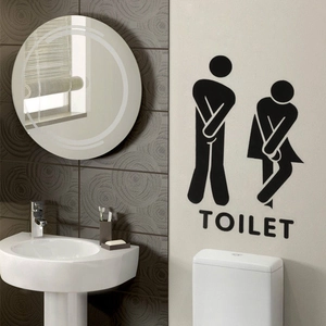 Funny bathroom wall sticker with cartoon silhouette and TOILET text on a grey tiled wall