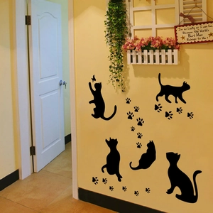Detail of creative black cat and paw prints wall decals for home interior decoration