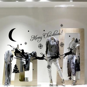 Detail showing black Merry Christmas window decals with Santa Claus sleigh and reindeer silhouette