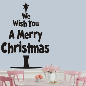 Christmas tree wall decal with Merry Christmas text on blue wall with pink chair