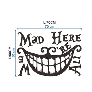 Macro detail of 'We're All Mad Here' wall sticker with Cheshire Cat smile, 70x50cm size