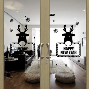 Modern Christmas reindeer and snowflake silhouette wall stickers on a glass door