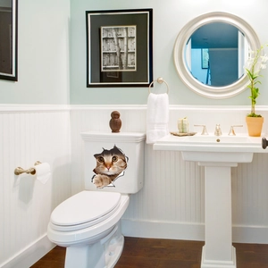 Detailed view of creative 3D orange cat sticker with realistic broken wall effect for bathroom