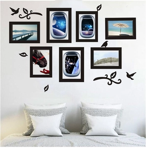 Detailed bedroom wall layout featuring seven black frames and bird silhouette stickers